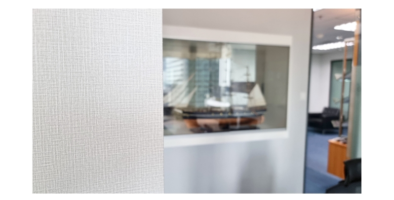 Textured white wallpaper with a display case in an office